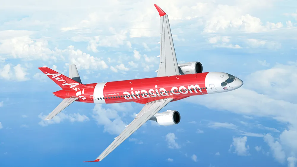Un A220 de AirAsia en vuelo visto desde arriba sobre un fondo de nubes